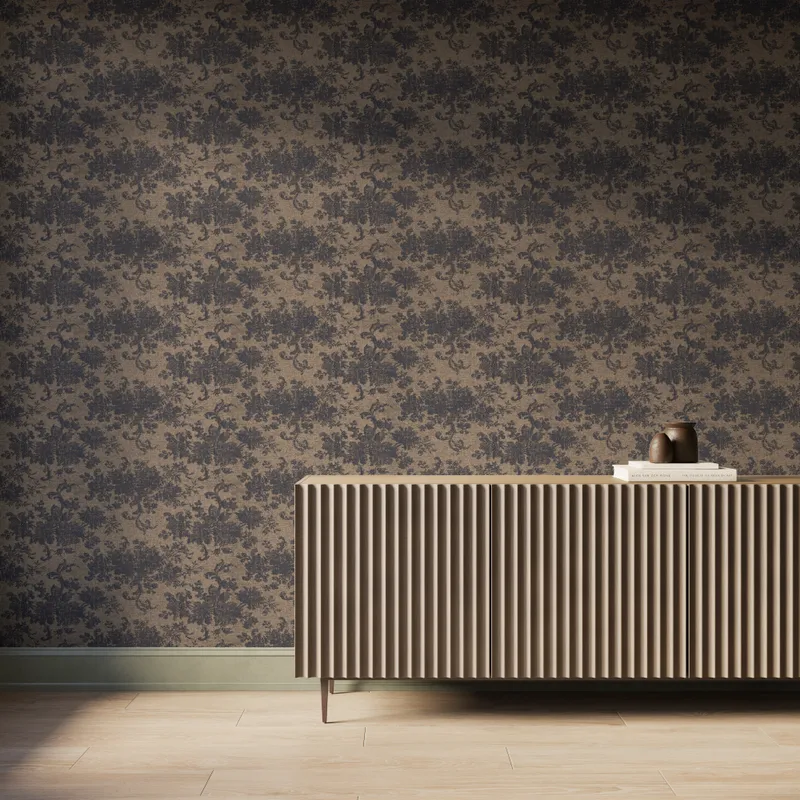 Interior scene featuring Brocade Wallpaper in Black/Tan II with a black damask floral motif over a matte brown background, styled with a fluted wood console cabinet, decorative books and vases, light wood flooring, and soft natural light.