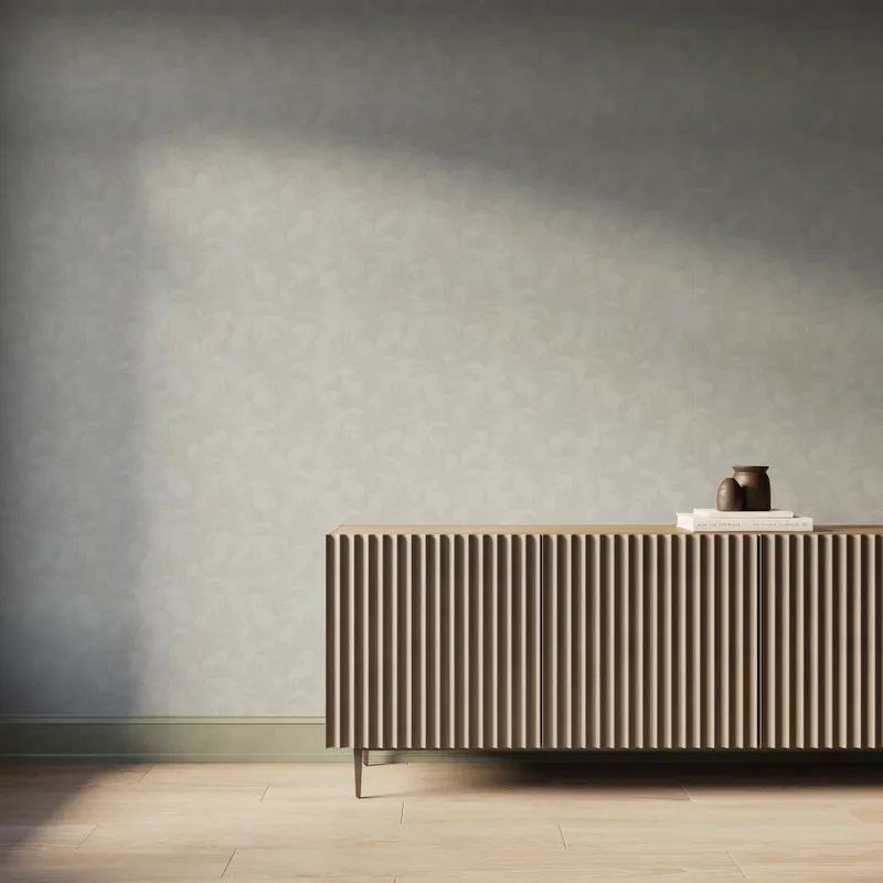 Off-white botanical wallpaper with repeating light gray leafy branch pattern, styled behind a modern fluted wood console.