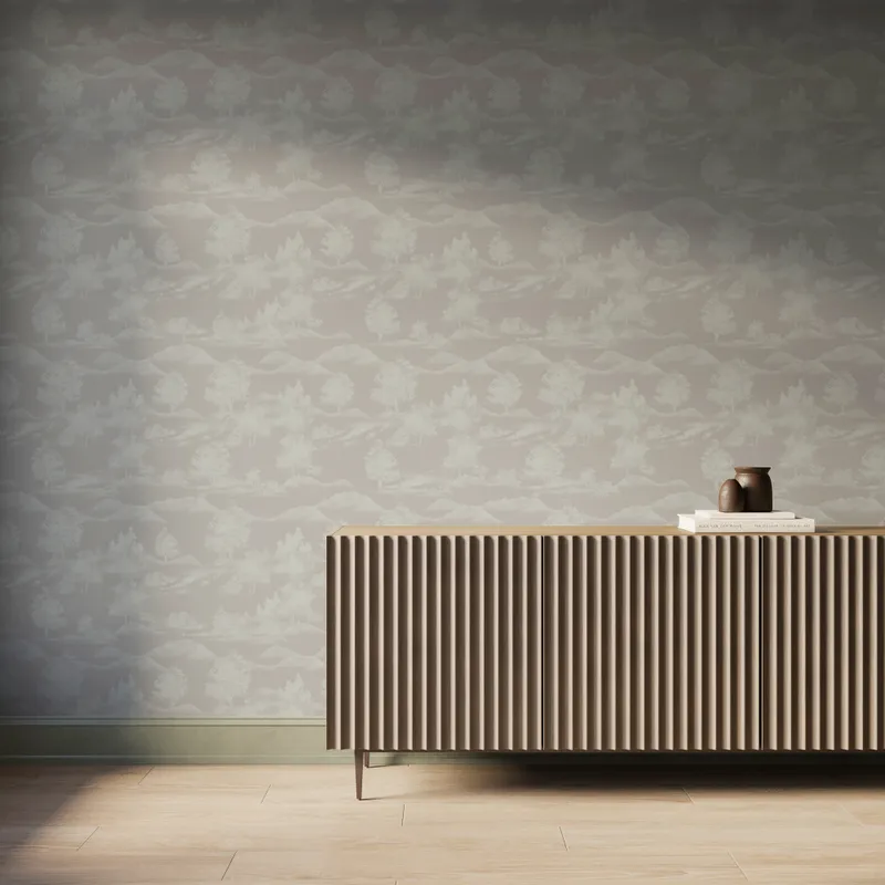Light gray scenic landscape wallpaper with white trees and mountain silhouettes behind a modern ribbed wood console table.