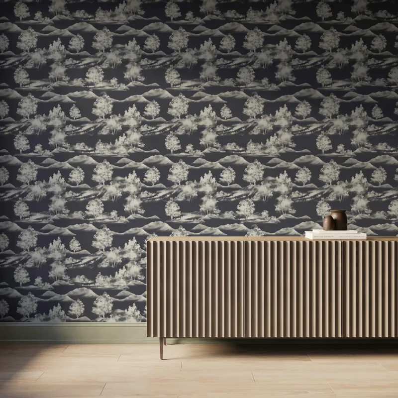 Dark gray scenic landscape wallpaper with white trees and mountain silhouettes behind a modern ribbed wood console table.