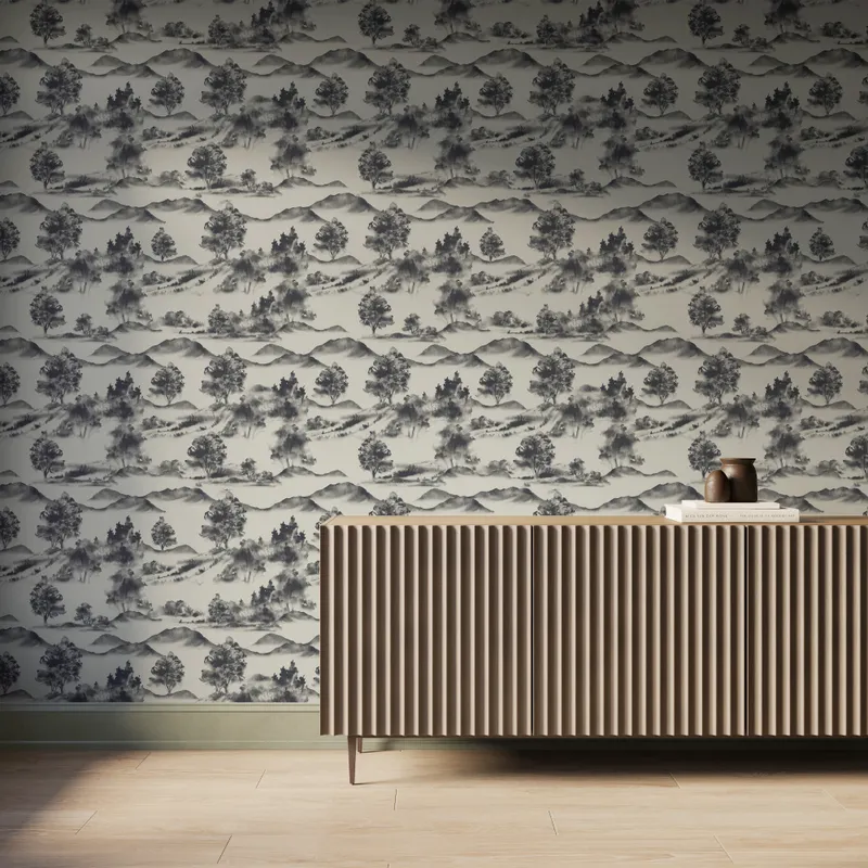 White scenic landscape wallpaper with dark gray trees and mountain silhouettes behind a modern ribbed wood console table.