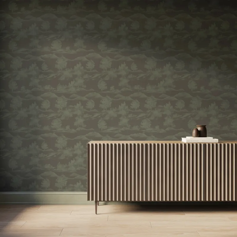 Earthy gray scenic landscape wallpaper with olive green trees and mountain silhouettes behind a modern ribbed wood console table.