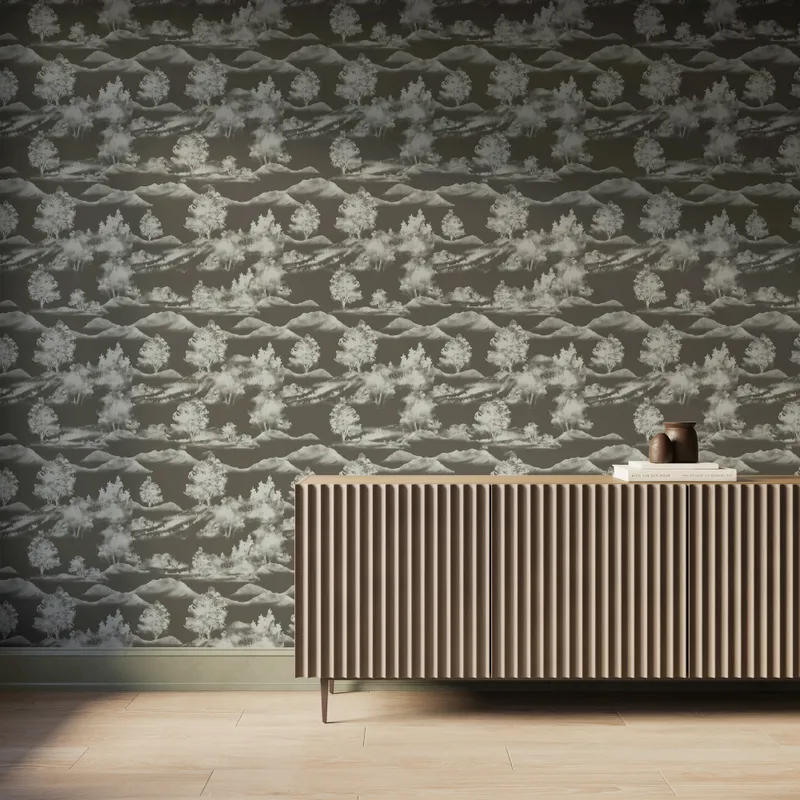 Olive green scenic landscape wallpaper with white trees and mountain silhouettes behind a modern ribbed wood console table.