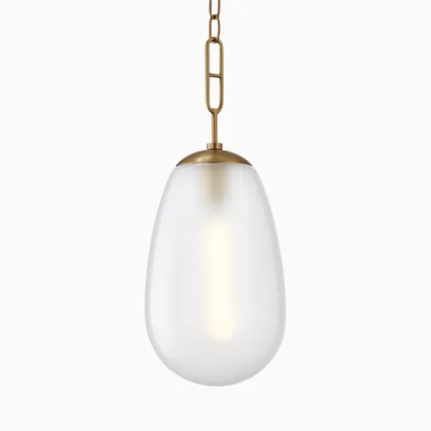 Large teardrop pendant with frosted glass shade and aged brass chain for a soft, modern glow.