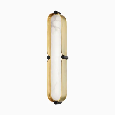 Wall sconce with aged brass capsule frame, dusk black accents, and frosted alabaster-style insert with integrated LED light.