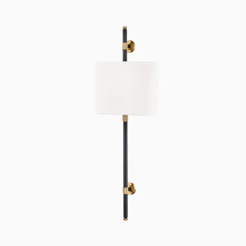 Wall sconce with white linen cylindrical shade, aged old bronze and black metal stem, and button-style mounts for soft ambient lighting.