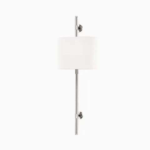 Wall sconce with polished nickel finish, white linen cylindrical shade, slim vertical stem, and button-like mounts for soft ambient lighting.