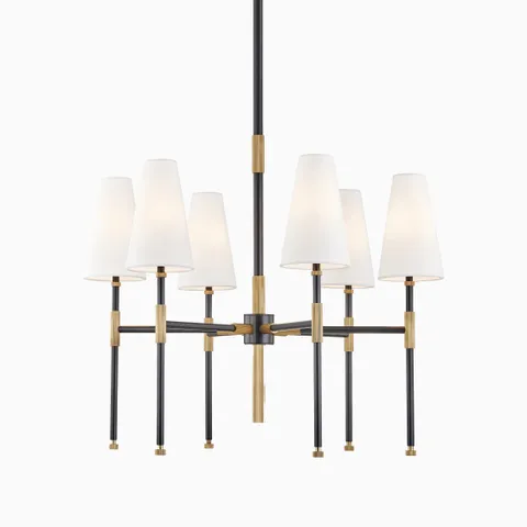 Chandelier with six white linen cone shades, aged bronze and black metal frame, radial silhouette, and central suspension stem.