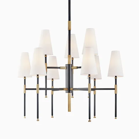 Chandelier with nine white linen cone shades, aged bronze and black metal arms, two-tier radial design, and central suspension stem.
