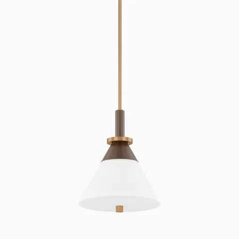 A bold blend of contrast, the Lennie 12” Pendant combines a flared white shade with patina brass and bronze accents, suspended from a sleek vertical rod.