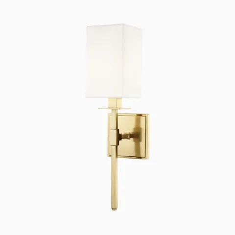 A white rectangular diffuser tops our Lockhart Wall Sconce in Aged Brass, creating contrast against the warm golden finish and its vertically extended arm.