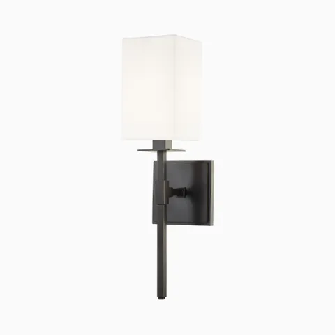 Our Lockhart Wall Sconce in Old Bronze features a white linen box shade with a matte black frame and clean square backplate, offering contrast and sculptural balance.