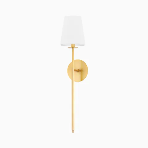Slim wall sconce with an aged brass rod and round backplate, topped with a tapered white fabric shade for a classic look.