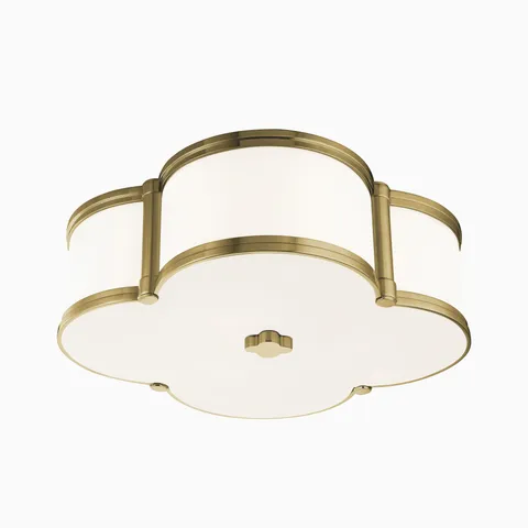 Elegant flush mount ceiling light with a quatrefoil silhouette, aged brass trim, and white diffuser for a soft, ambient glow.