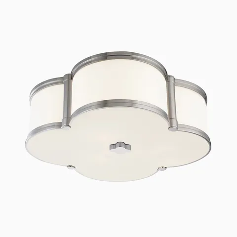 Polished nickel flush mount ceiling light with a quatrefoil silhouette and white diffuser, finished with a matching knob accent.