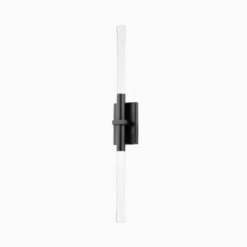 Modern vertical wall sconce with slender textured glass rods and a black brass rectangular mount, offering a sleek, linear profile.