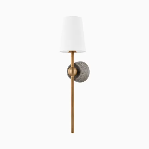 Transitional wall sconce with a patina brass rod, stone-textured backplate, and tapered white fabric shade for a refined look.