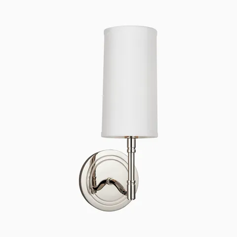 Polished nickel wall sconce with round backplate, curved arm, and tall cylindrical white fabric shade for a sleek modern lighting accent.