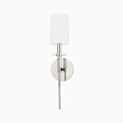 Polished nickel wall sconce with white cylindrical shade, slim vertical rod, and round backplate for a sleek modern lighting accent.