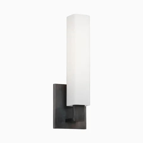 Vertical wall sconce with tall opal glass diffuser and minimalist old bronze backplate, offering bold contrast and modern structure.