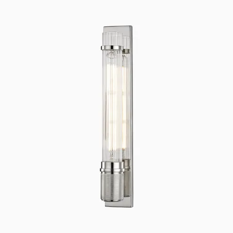 A fluted glass cylinder and textured socket define the Tyson Wall Sconce in Polished Nickel, offering crisp symmetry and radiant metallic shine in a compact vertical form.
