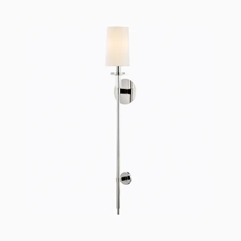 Polished nickel wall sconce with tall cylindrical white shade, slim vertical rod, and round backplate for a sleek modern lighting accent.