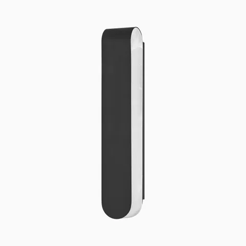 Modern wall sconce in black brass with a sleek, elongated oval shape and brushed metal edge, mounted vertically on a white background.