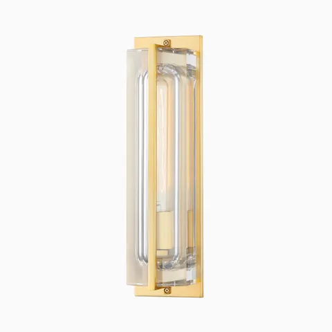 Slim wall sconce with clear glass tubing framed in aged brass for a sleek, modern glow.