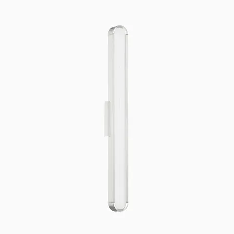Slim chrome wall sconce with a tall frosted glass shade, offering modern, streamlined lighting for hallways or bathrooms.
