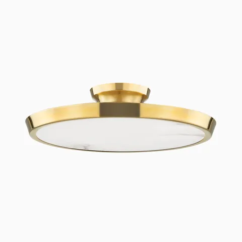 Modern flush mount light in aged brass finish with a wide flat circular shade and low-profile design for refined contemporary spaces.