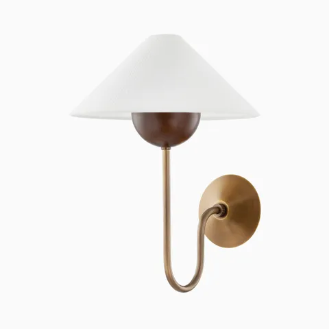 Mid-century inspired sconce with patina brass arm, walnut accent, and a wide white fabric shade.