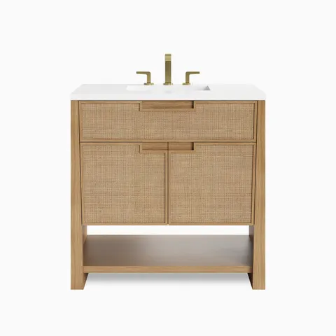 36 inch oak single bathroom vanity with woven cane cabinet doors, white countertop, brass faucet, and open shelf storage.