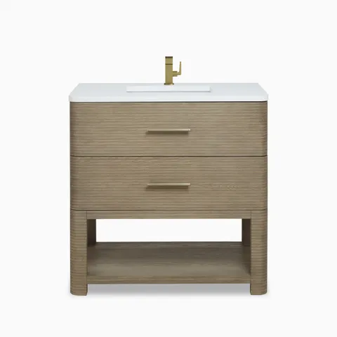 Paxton 36-inch single vanity in pebble oak with white countertop, integrated sink, brass faucet, two drawers, and open shelf.