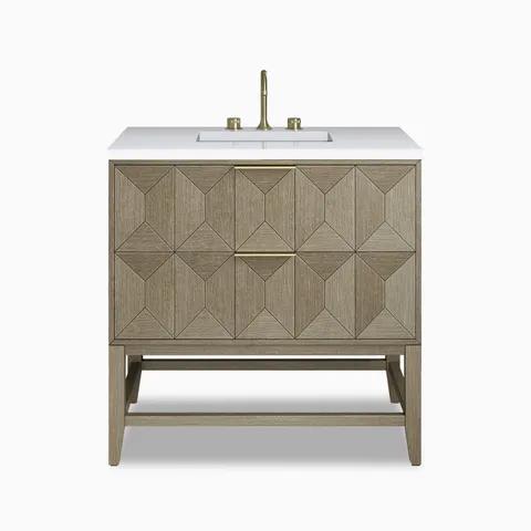 Gwen 36" single vanity in pebble oak featuring sculptural diamond-patterned drawer fronts and brass accents beneath a white quartz sinktop.