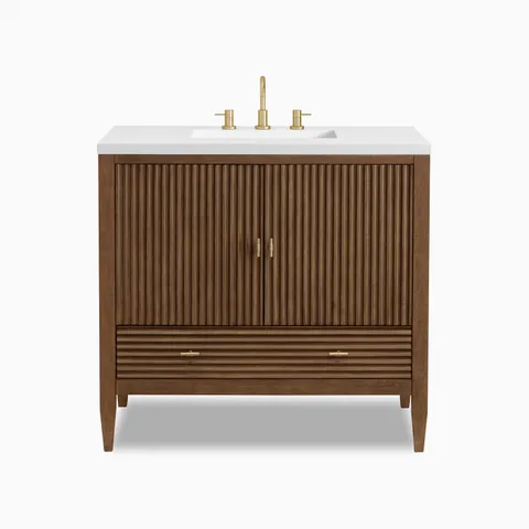 Sasha 36" freestanding single vanity in mid-century walnut featuring fluted doors and brushed brass hardware, topped with a sleek white countertop.