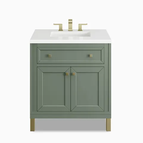 A compact 30 inch single vanity in Smokey Celadon with muted green cabinetry, framed panel doors, a spacious top drawer, brass hardware, and a White Zeus Silestone countertop.