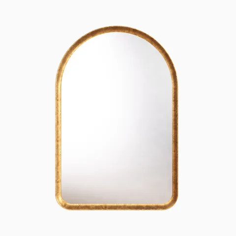 Arched mirror with a classic silhouette, framed by a narrow border finished in a rustic, warm metallic sheen.