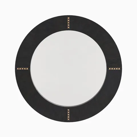 Round mirror wrapped in dark brown cowhide with rich tonal depth and antique brass rivet accents inspired by classic saddle craftsmanship.