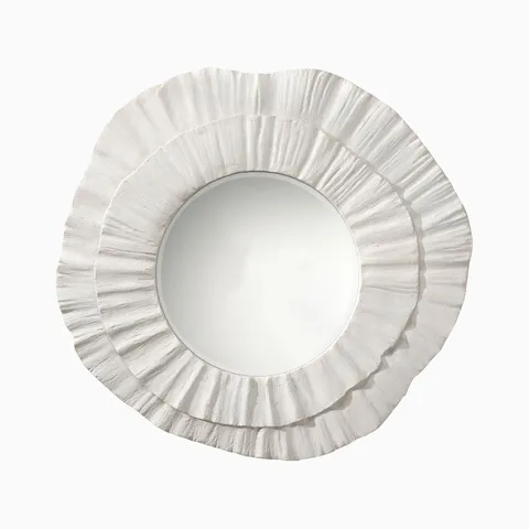Round wall mirror with layered, petal-like white resin frame, featuring a matte concrete-inspired texture and sculptural organic form.