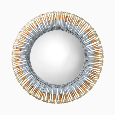Round mirror framed by layers of hand-carved mango wood beads, creating a dimensional halo with soft blue-gray and warm natural tones.
