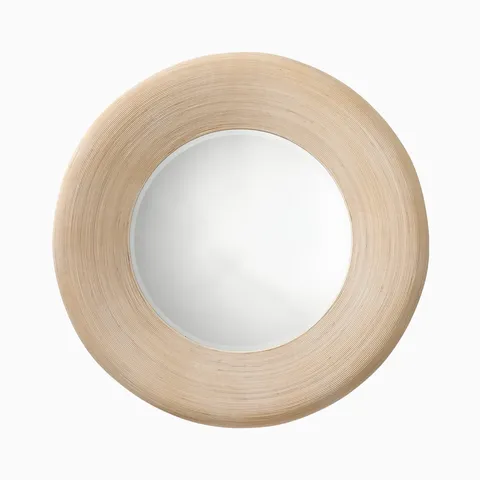 Round Meliora mirror with a cream bamboo frame featuring fine concentric grooves and a warm beige finish for a light, organic look.