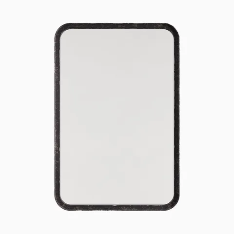 Rounded rectangular mirror with a classic silhouette, framed by a narrow border finished in a rustic, dark metallic sheen.