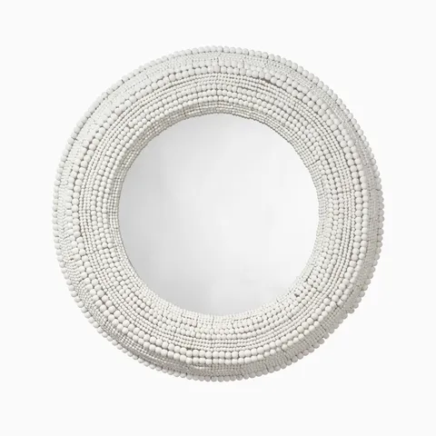 Round wall mirror framed with layered white mango wood beads, creating a richly textured, dimensional halo with natural organic variation.