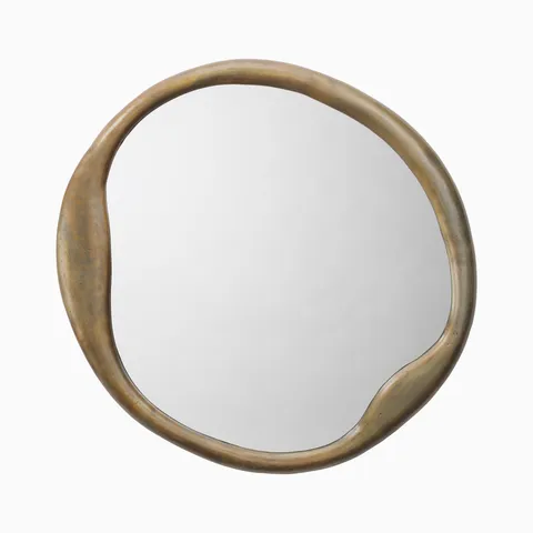 Round wall mirror with an organically shaped metal frame in an aged brass finish, featuring subtle patina and soft curves for a sculptural, modern look.