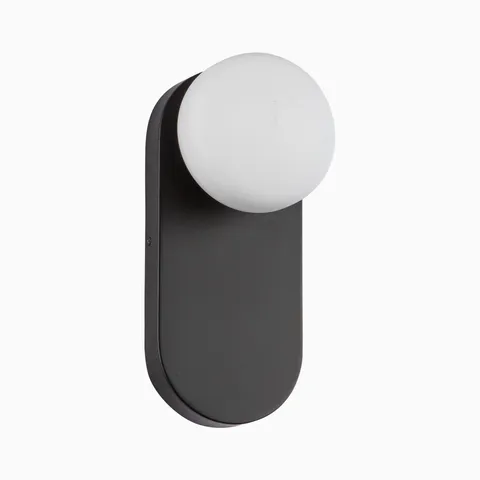 Matte black wall light with an elongated rounded backplate and a floating opal glass globe, offering a clean, modern and versatile silhouette