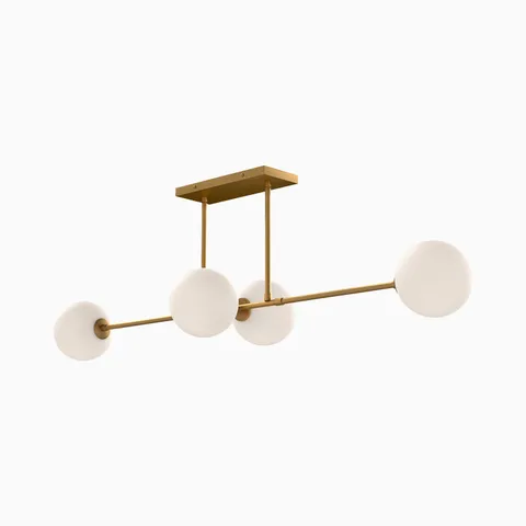 Modern linear pendant light with four frosted glass globe shades on a brushed brass horizontal metal frame.