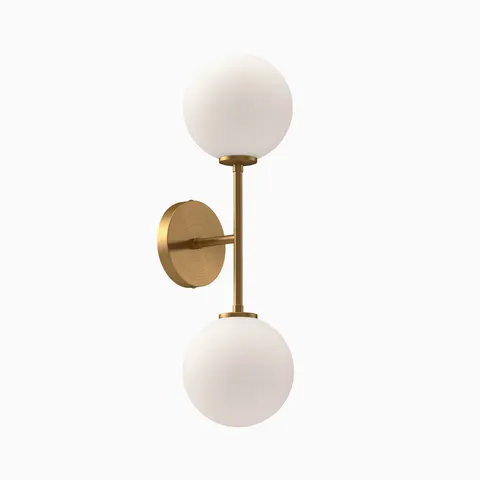 Modern wall sconce with dual frosted glass globe shades and brushed brass vertical arm and round backplate.