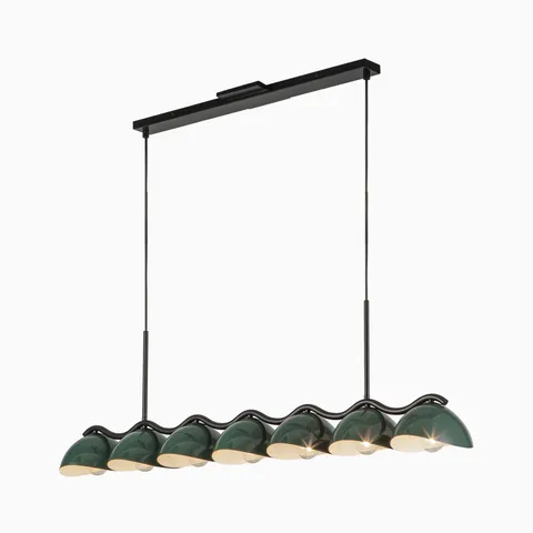 Linear pendant light with seven dark green dome shades on black bar, warm bulbs glowing beneath.