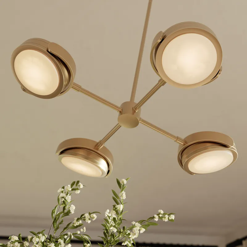 Modern LED pendant light with brushed gold finish, four adjustable round light heads, and floral arrangement.