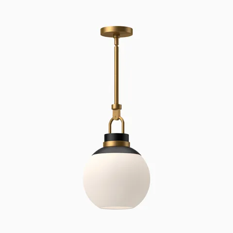 Aged gold pendant light with a matte opal glass globe shade and black accents, suspended from a matching aged gold canopy.